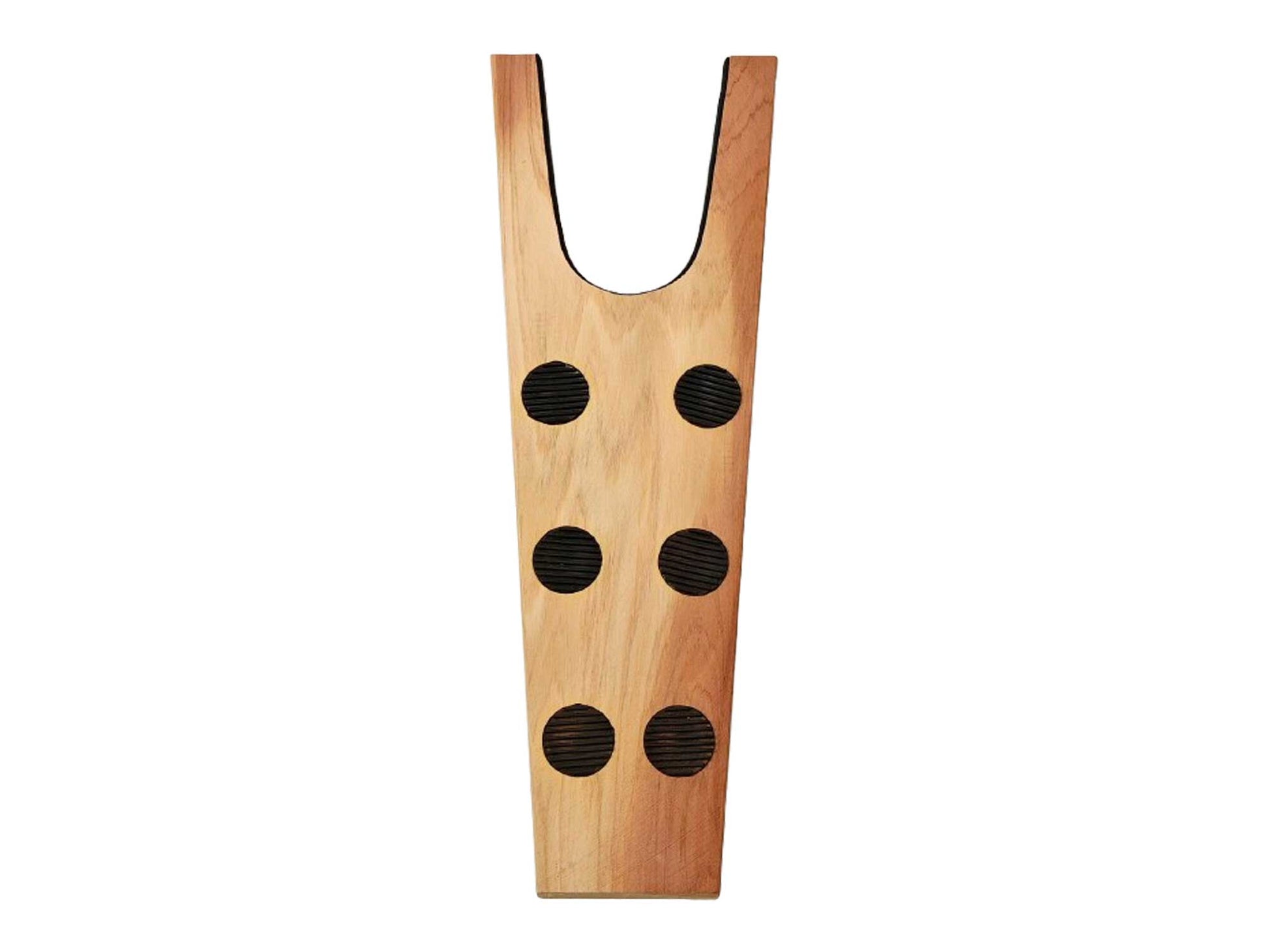 The *Seconds* Cedar wood boot jack by Cathcart Elliot is made from aromatic cedar and features a U-shaped slot with six black rubber circles in vertical pairs for efficient boot removal.