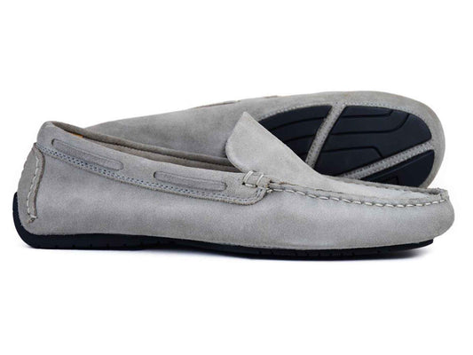 Orca Bay SILVERSTONE mens grey suede leather driving shoes—one lying flat, one angled to show the black rubber sole and visible stitching—combine classic style with comfort.