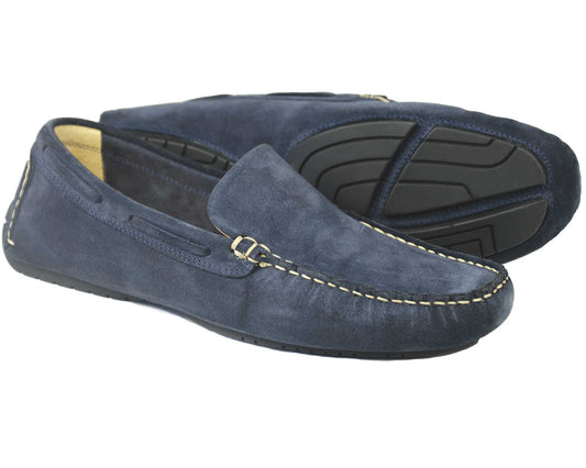 A pair of SILVERSTONE Mens Navy Suede Leather Driving Shoes by Orca Bay, featuring visible white stitching and black rubber soles. One shoe stands upright; the other is on its side, displaying the detailed tread pattern.