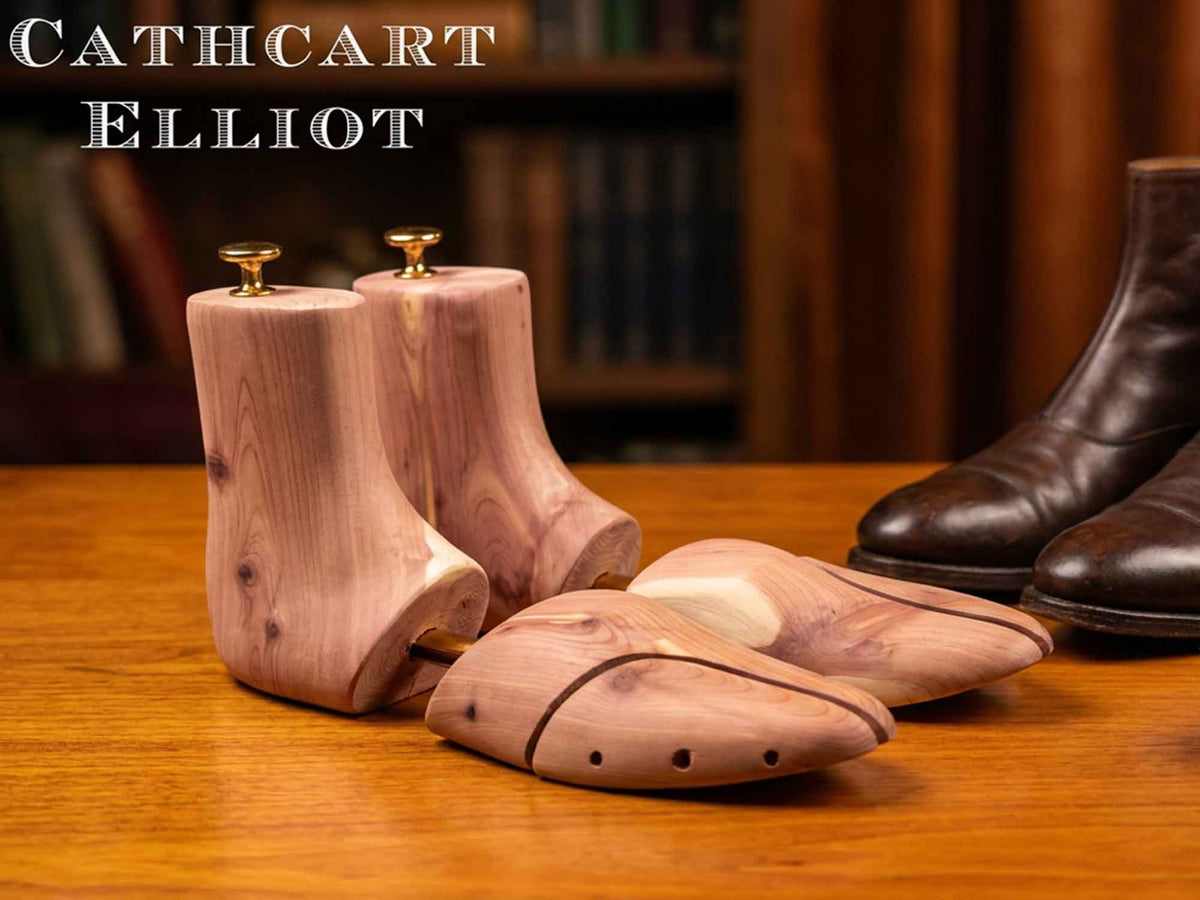 Cathcart Elliot Tall Cedar Boot Trees for Chelsea Boots resting on a wooden surface.