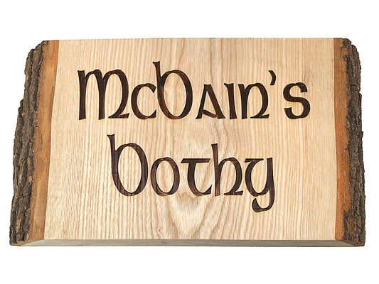 The Cathcart Elliot Engraved Wood Door Sign features rustic live edge wood with bark sides, artistically engraved with “McDain’s Bothy”—a charming personalized wall accent for any home.